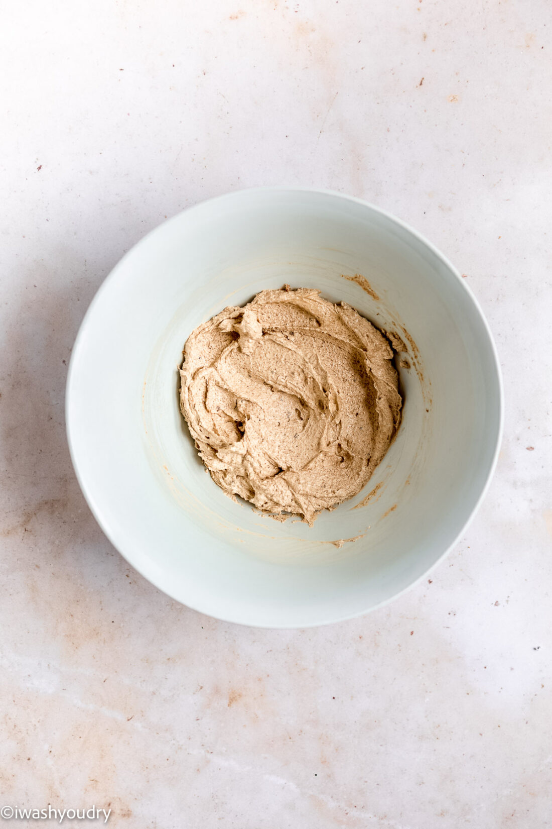 Creamed butter and sugar in light colored bowl. 