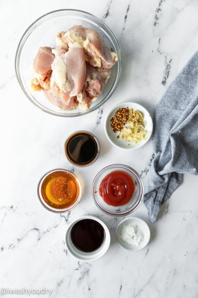 ingredients for garlic chicken on white table with honey.