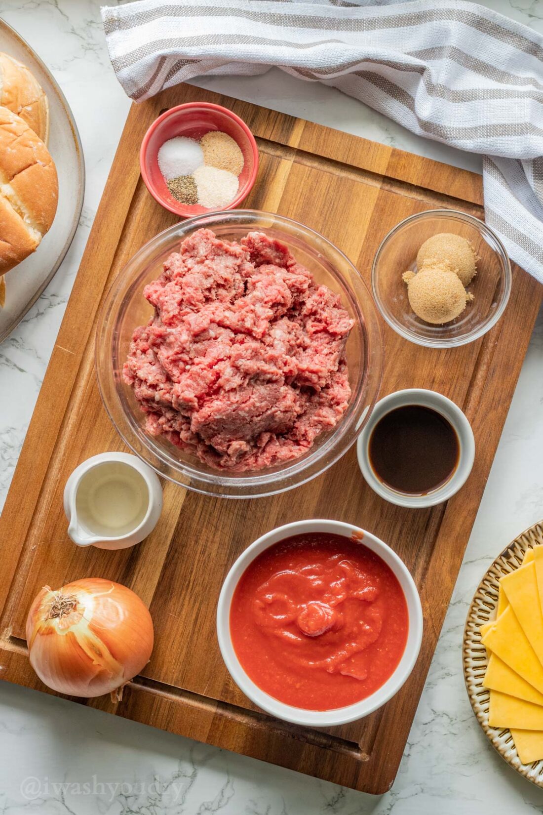 Ingredients for sloppy joes on a wood cutting board. 