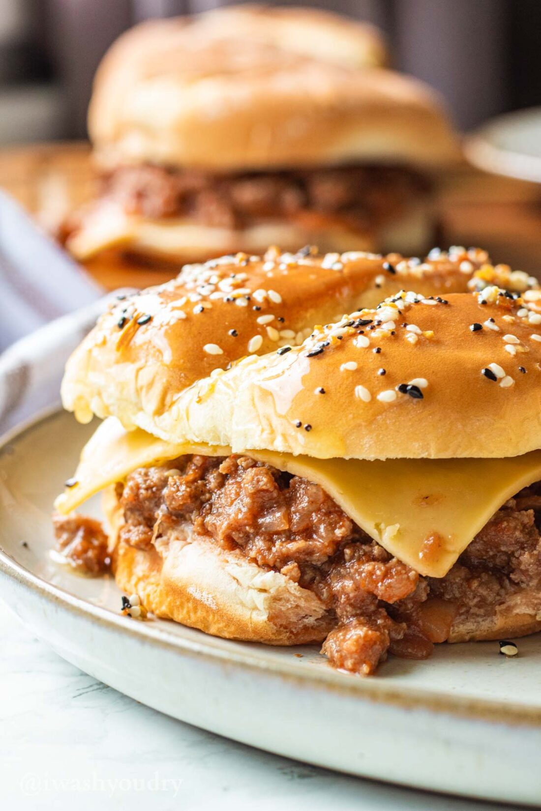 Slow Cooker Sloppy Joe with cheese slice on white plate