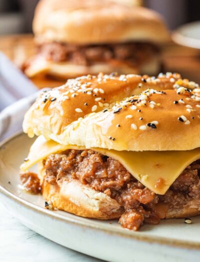 Slow Cooker Sloppy Joe with cheese slice on white plate