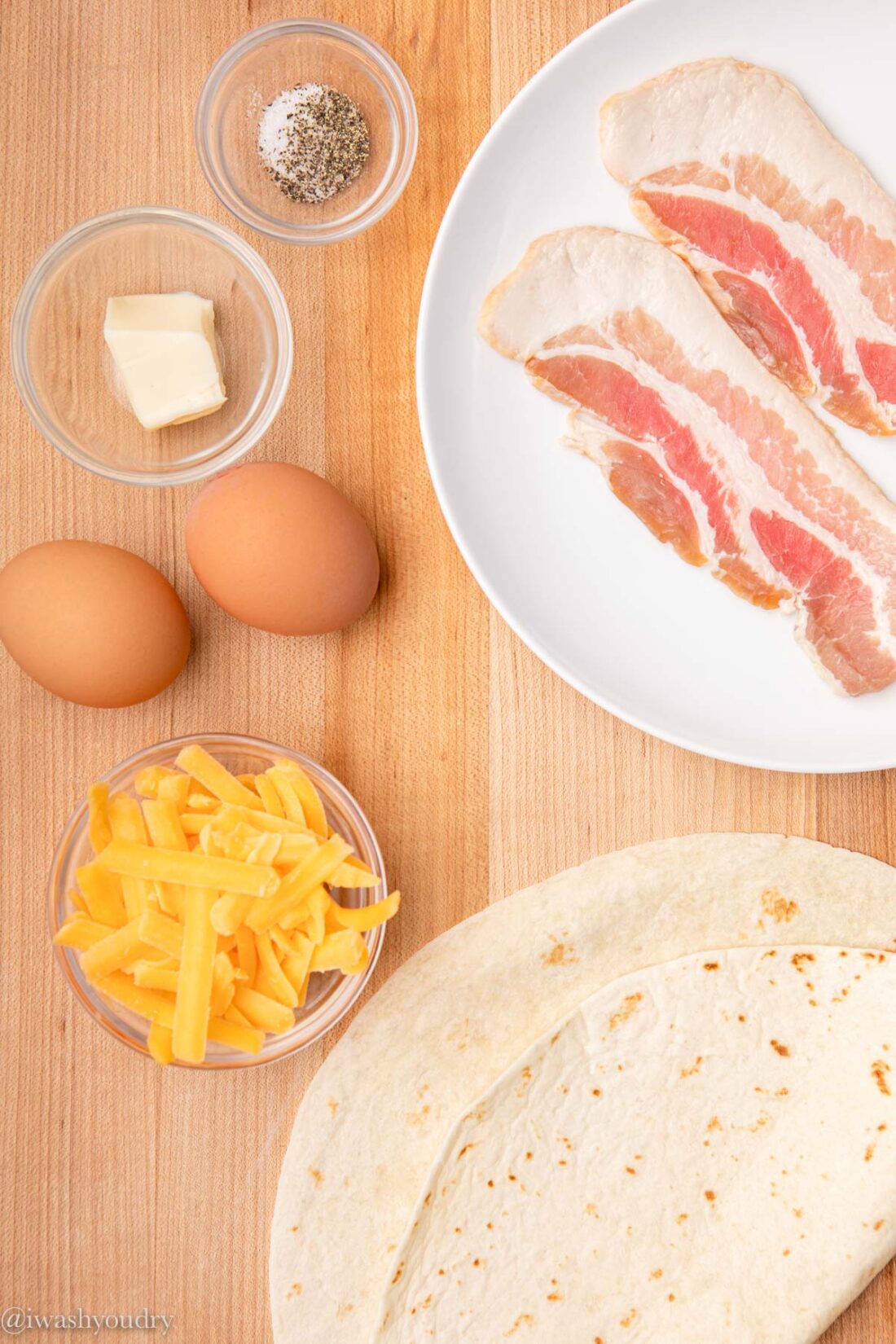 Ingredients for easy breakfast quesadillas on wood cutting board. 