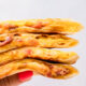 Hand holding stack of cooked breakfast quesadillas.