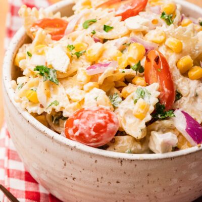 bowl of pasta salad with corn on red napkin