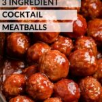 Cooked 3 ingredient meatballs in black slow cooker.