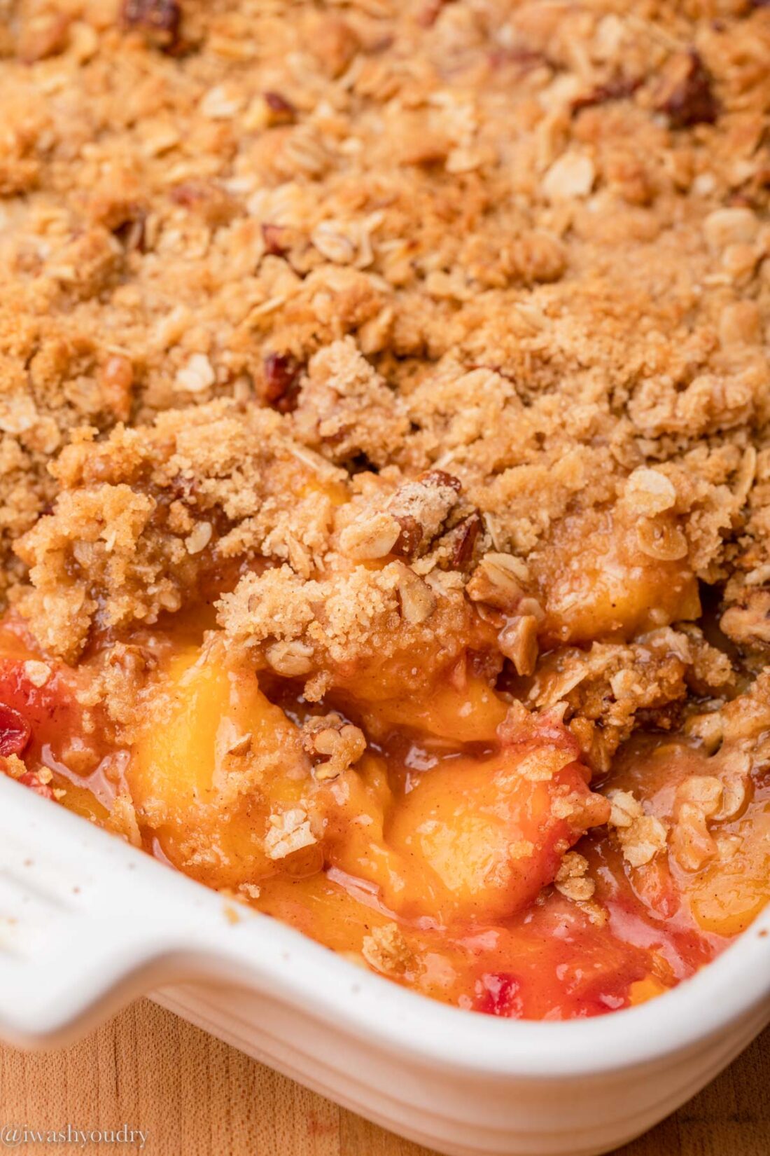 Easy Peach Crisp in white baking dish.