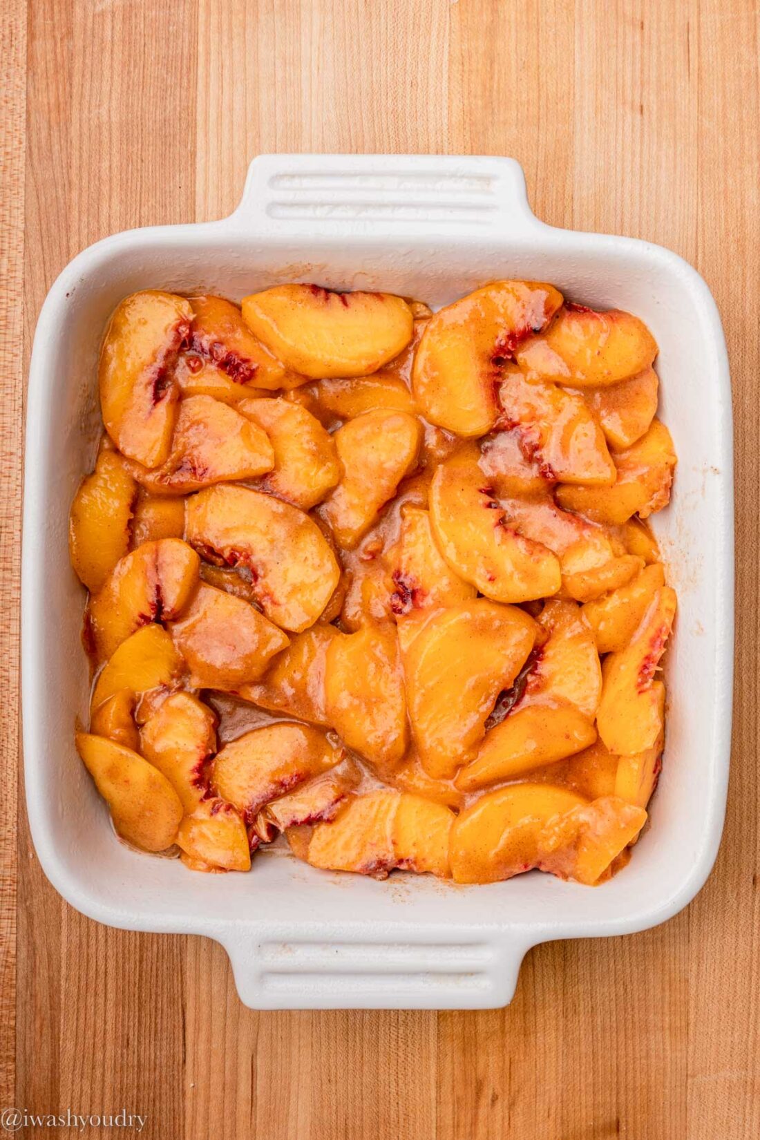 Peach filling in white baking dish.