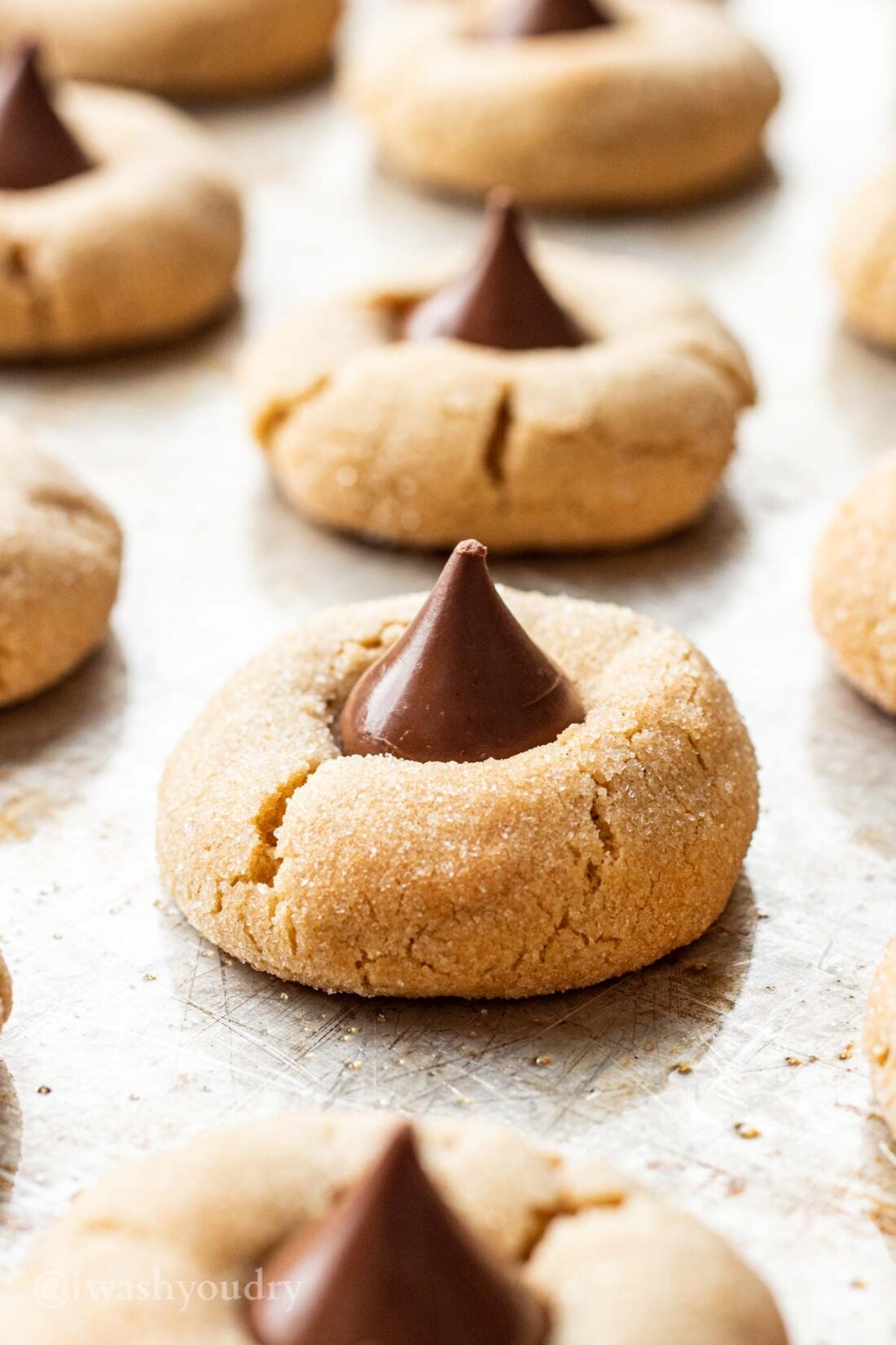 Baked Peanut Butter Kiss Cookies on metal baking sheet. 