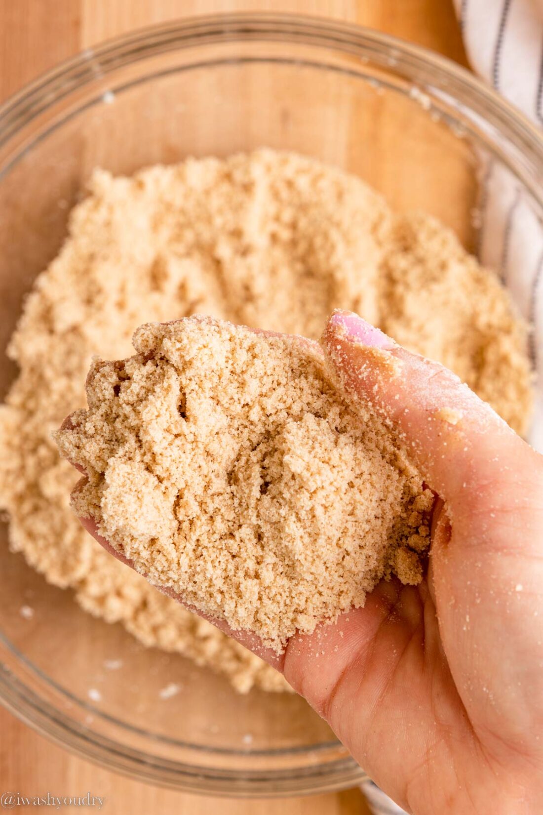 Hand holding dutch crumb topping. 