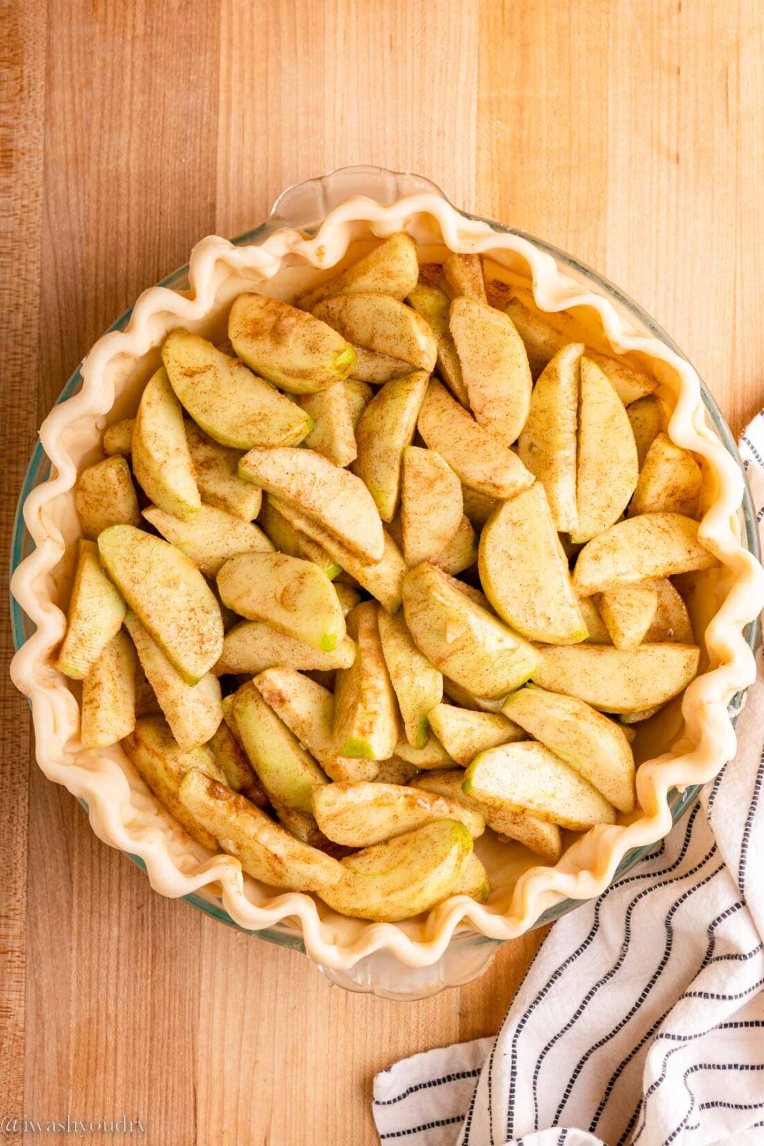 Raw apple pie filling in raw pie crust. 