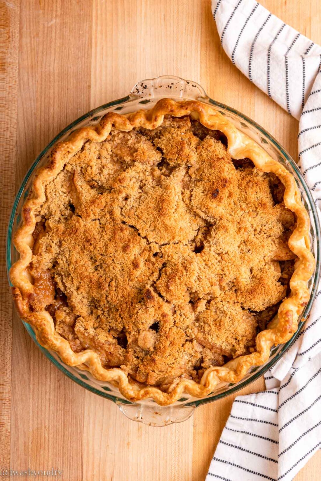 Baked Dutch Apple Pie with dish towel. 