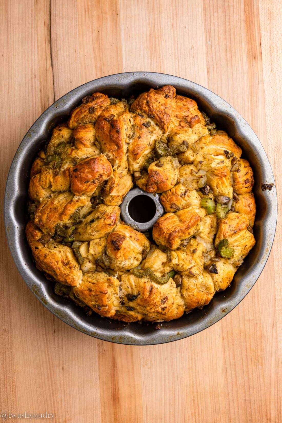 Cooked pull apart stuffing ring in a fluted baking pan. 