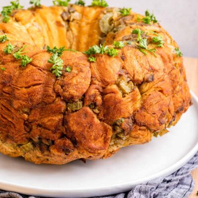 Baked Pull Apart Stuffing ring on white plate.