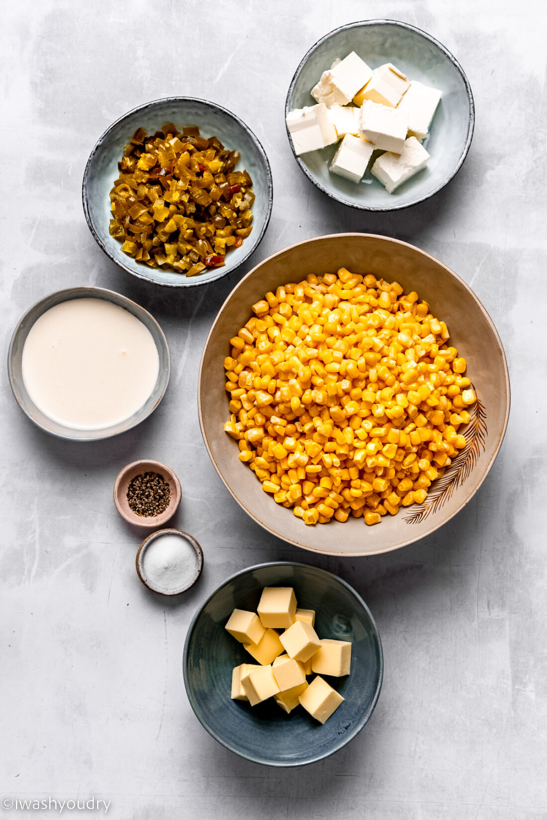 Slow cooker creamed corn ingredients on marble countertop. 