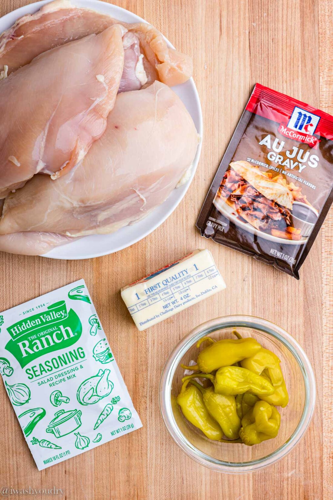 Ingredients for slow cooker mississippi chicken on wood counter. 