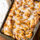 cinnamon roll bake with apples and icing for an easy breakfast.