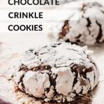 Baked chocolate crinkle cookies on metal pan.