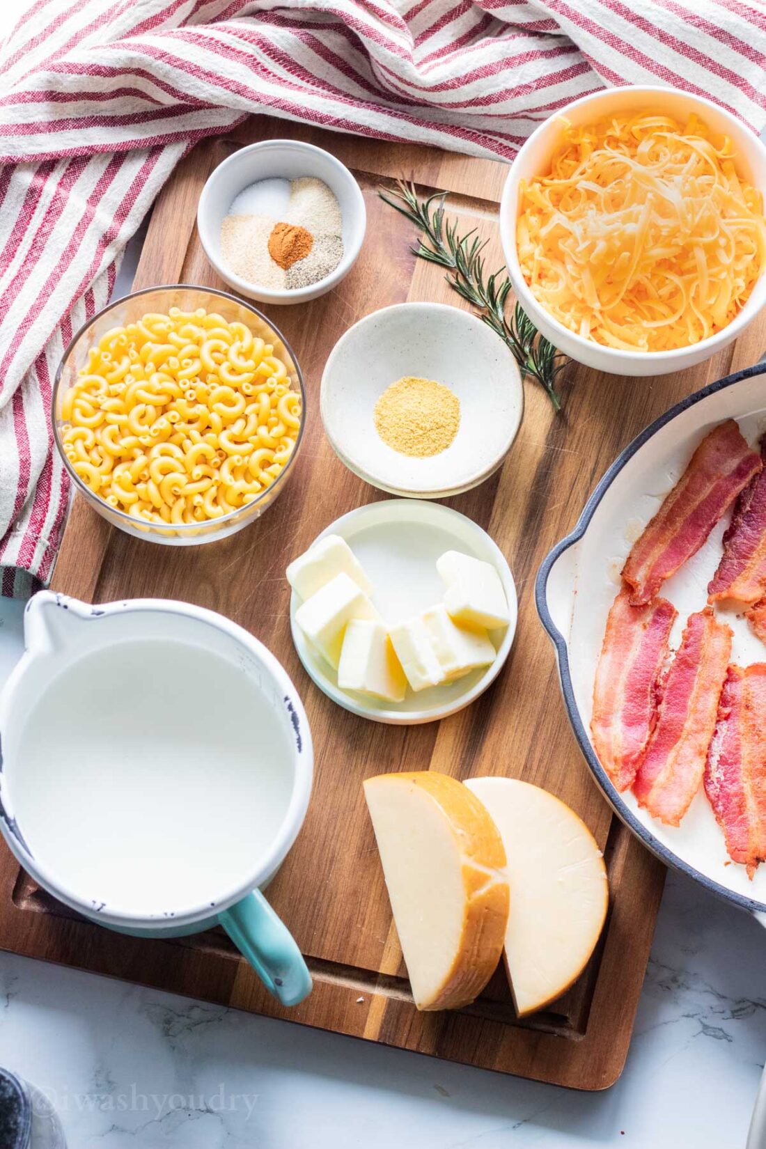 Ingredients for bacon mac and cheese on a wook cutting board. 