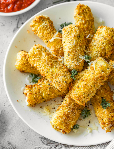 Plate of mozzarella sticks with parsley.