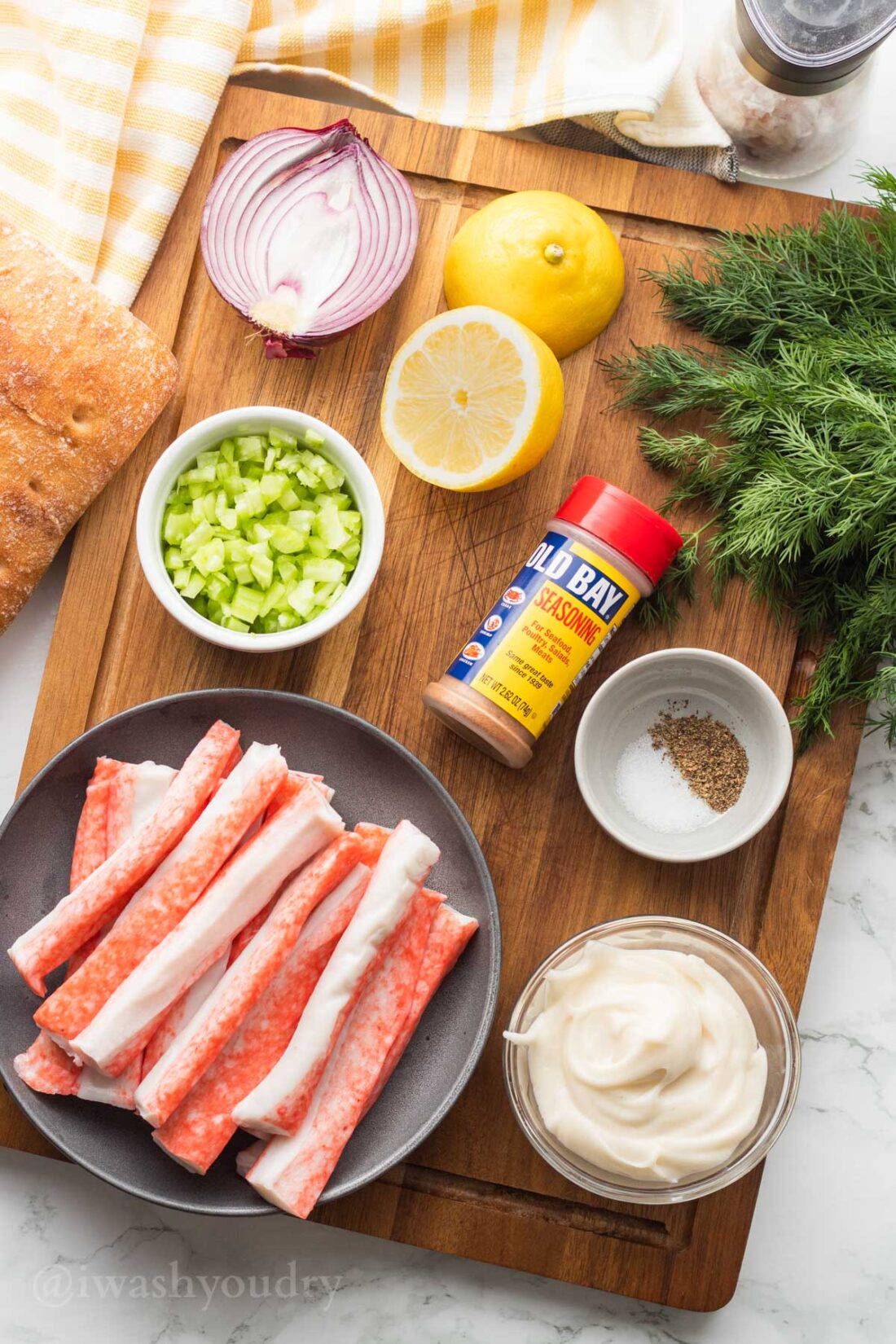 ingredients for crab salad on wooden surface with imitation crab.