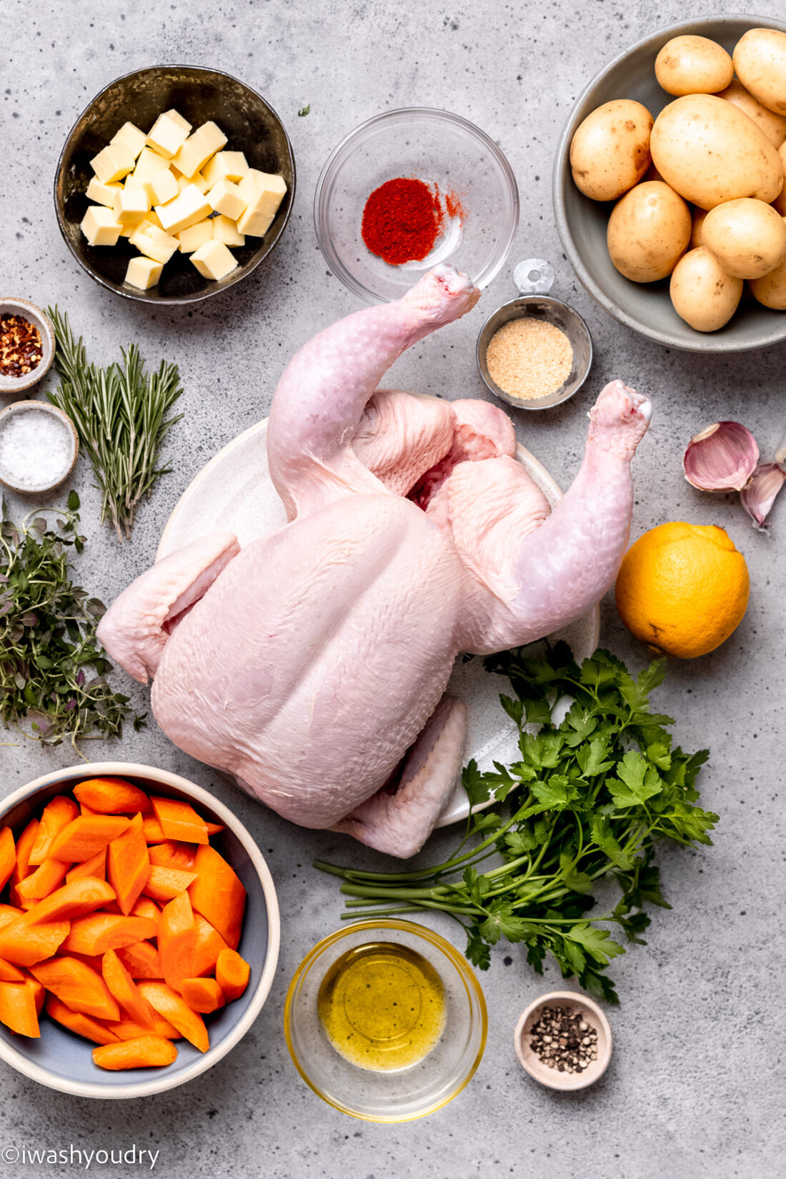 Ingredients for Spatchcock chicken with potatoes on concrete surface. 