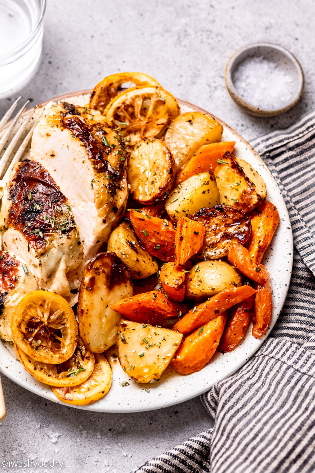 Sliced Spatchcock chicken and veggies on white plate. 