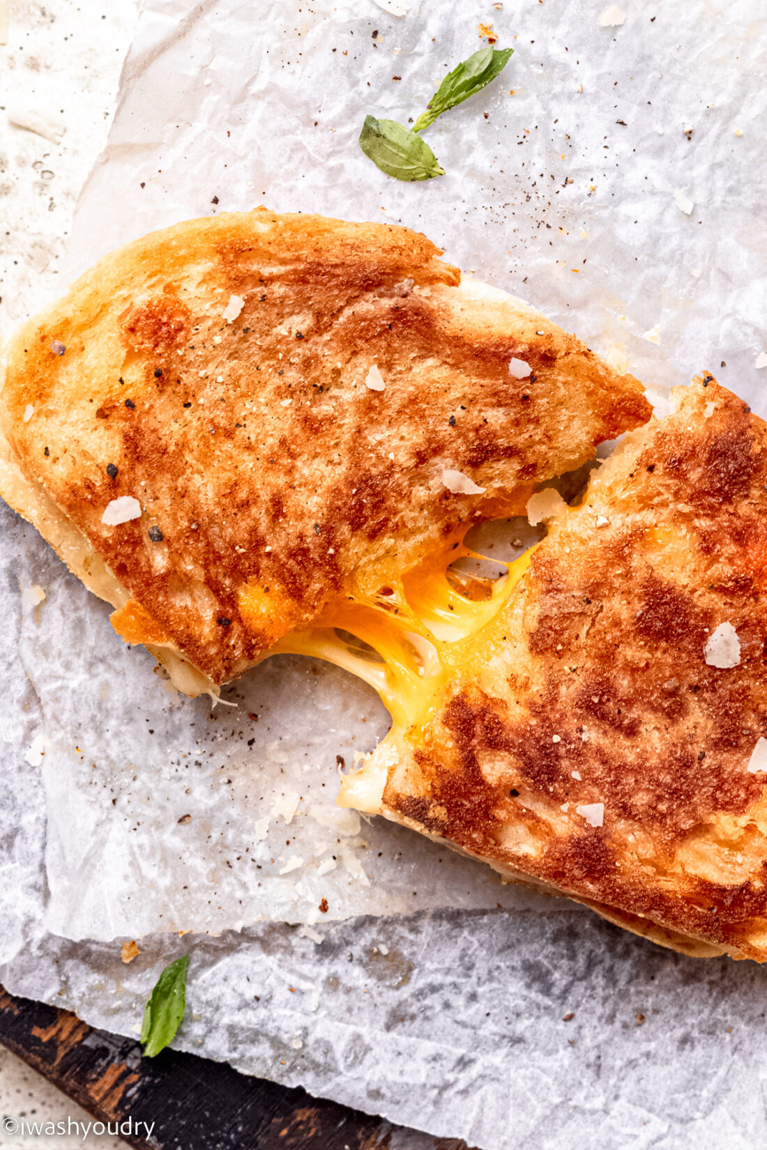 Cooked grilled cheese sadwich on white countertop. 