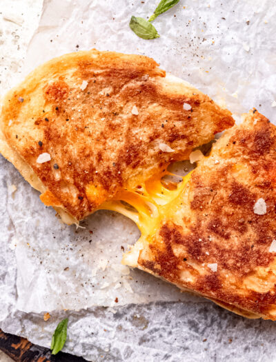 Cooked grilled cheese sadwich on white countertop.