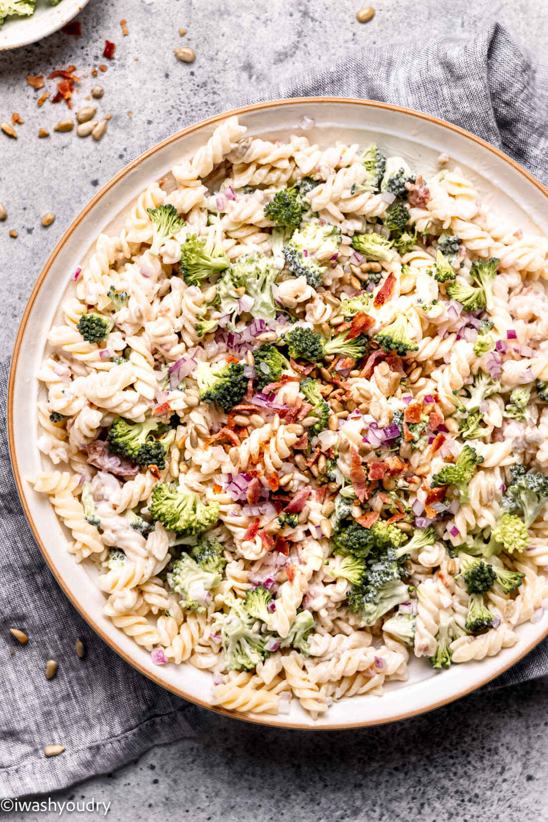 bowl of pasta salad with broccoli and bacon.