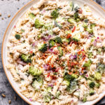 bowl of pasta salad with broccoli and bacon.