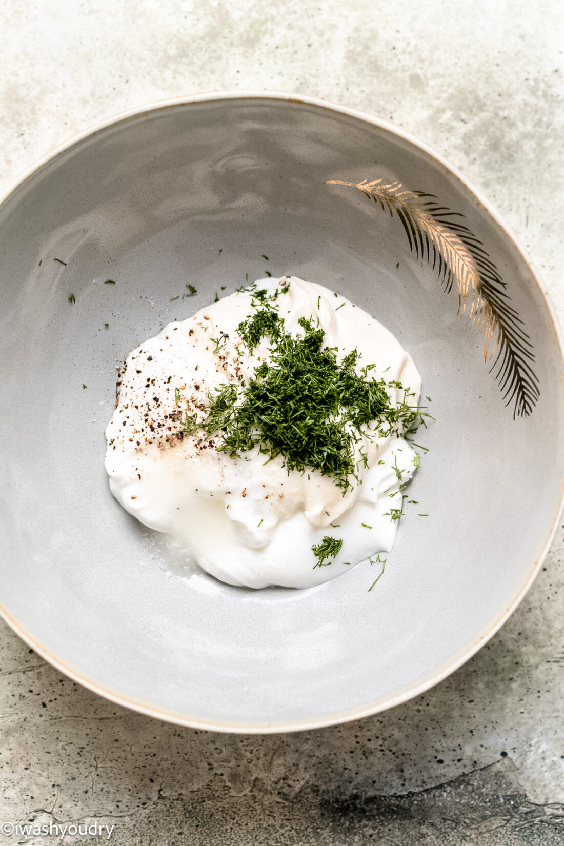 Ingredients for creamy salad sauce in a white bowl. 