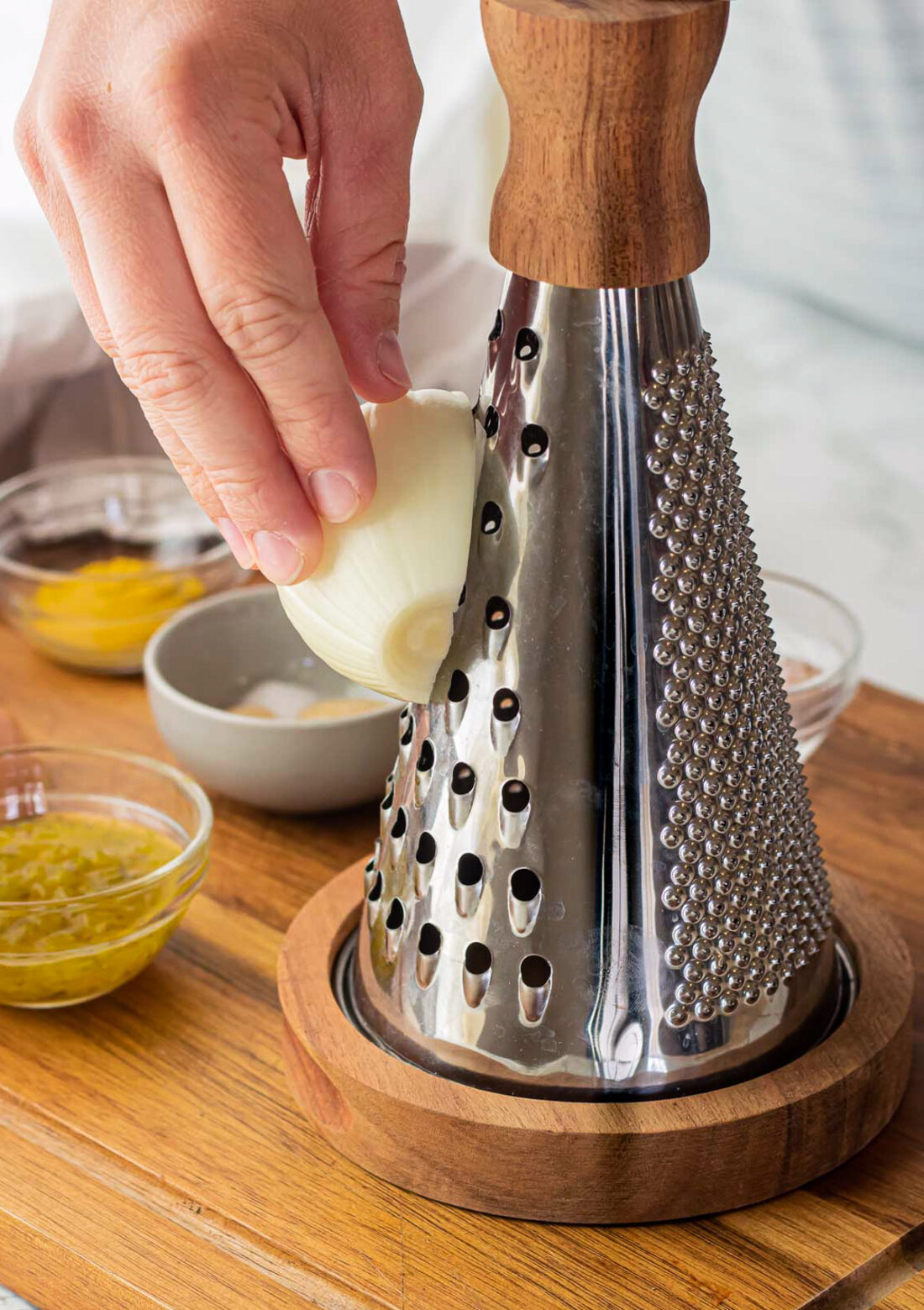 grating onion with cheese grater for homemade burger sauce.