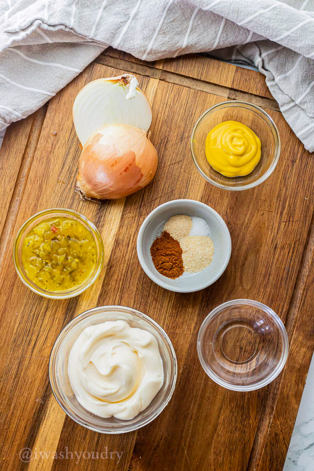 ingredients for sauce on wooden surface with grated onion.