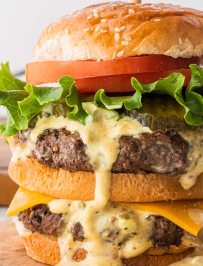 Big Mac Sauce recipe on a juicy hamburger with tomatoes and lettuce.