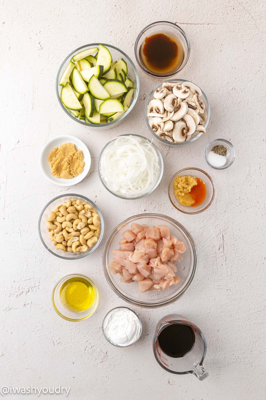 Ingredients for cashew chicken in glass bowls. 