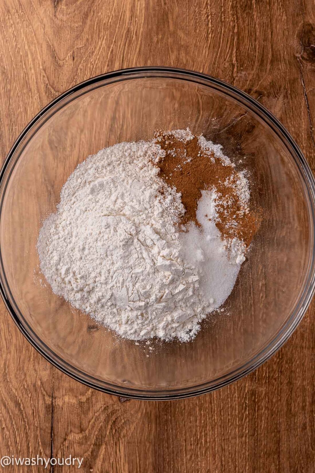 Dry ingredients for pumpkin pancakes in glass mixing bowl. 