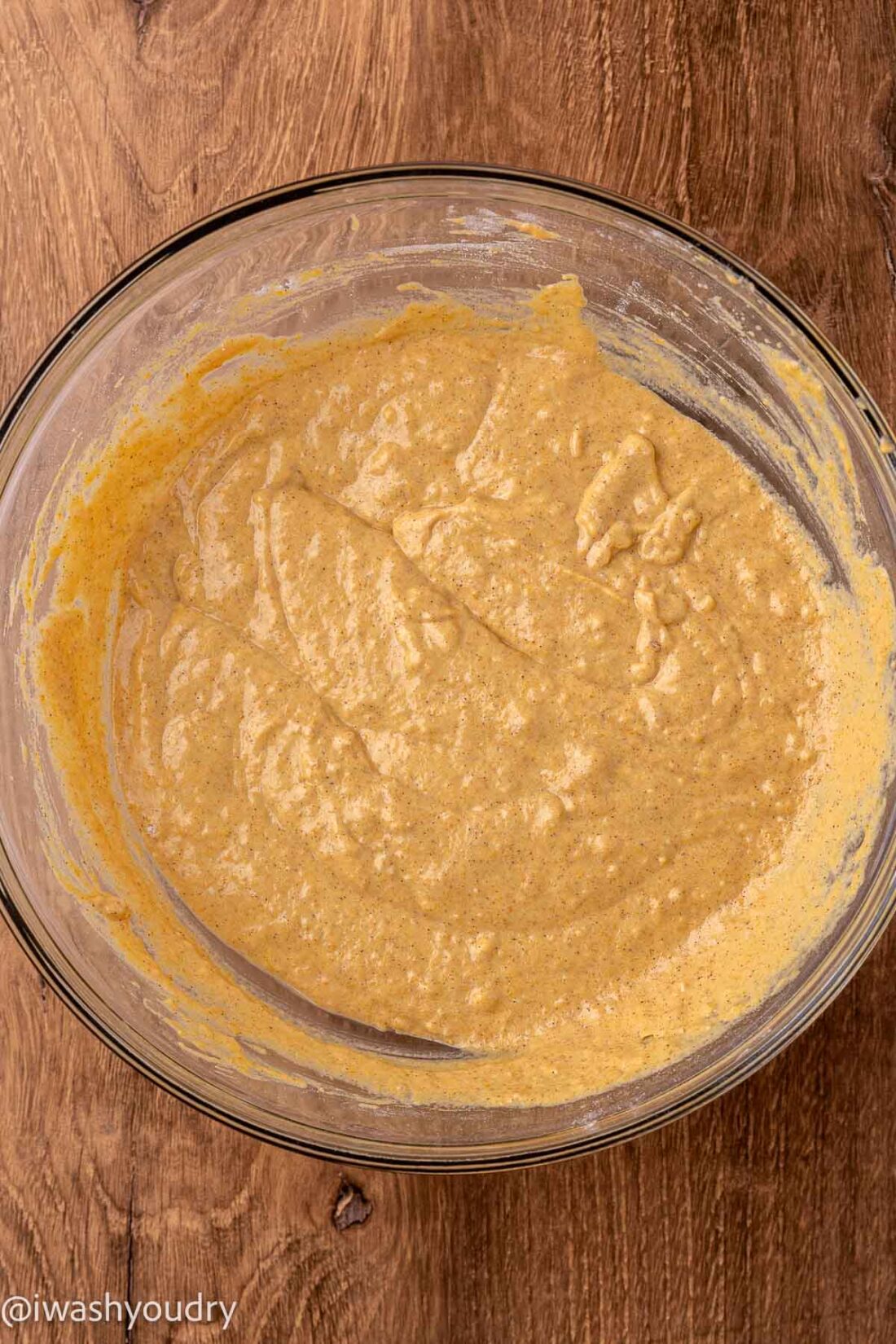 Raw pumpkin pancake batter in glass bowl. 