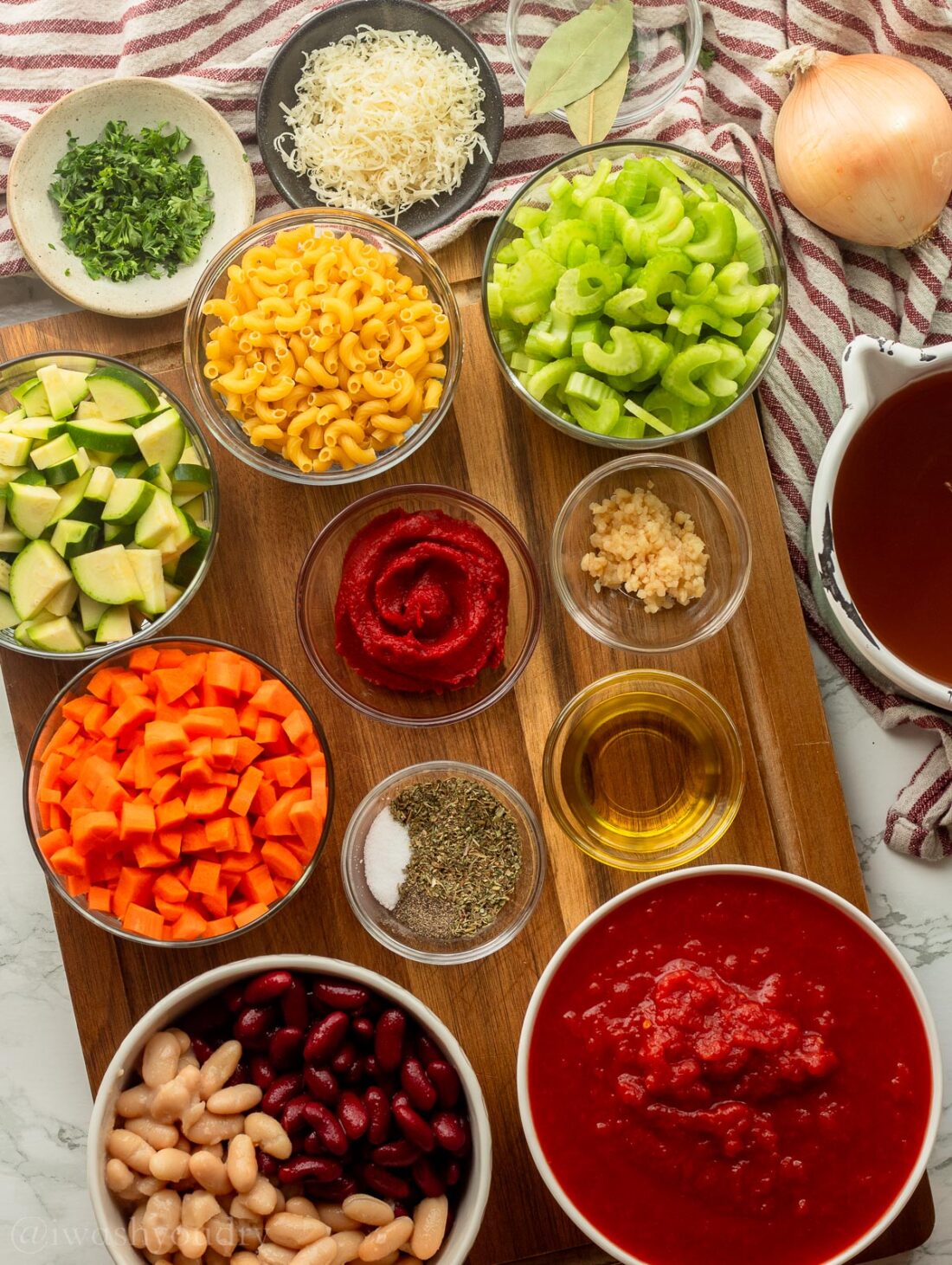 ingredients for soup with tomatoes and beans on wooden surface.