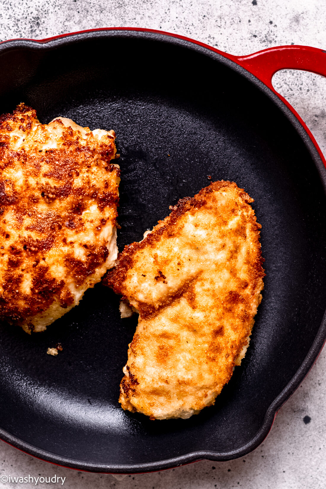 Cooking breaded chicken in skillet. 