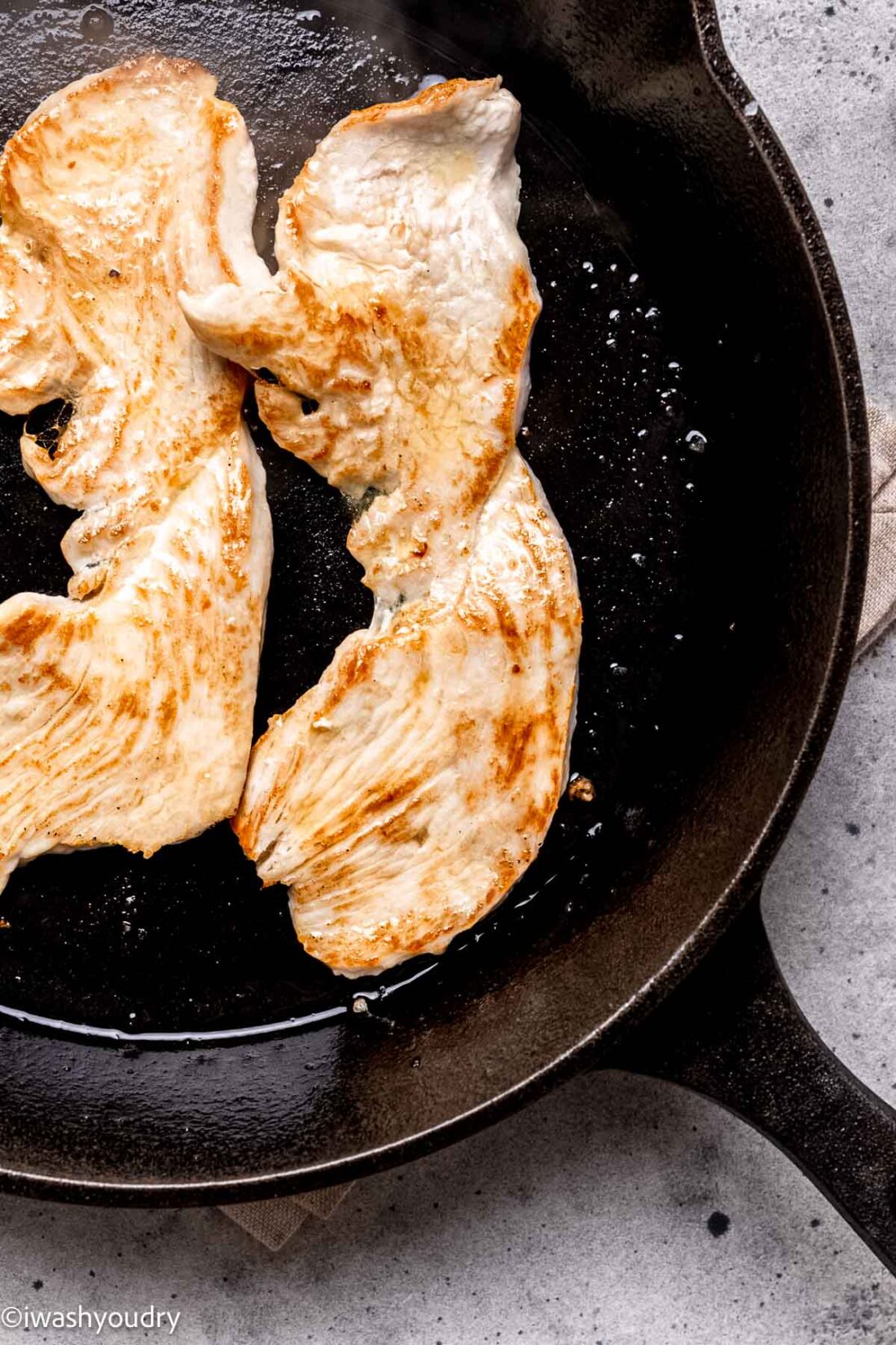 Cooking turkey cutlets in olive oil in skillet. 