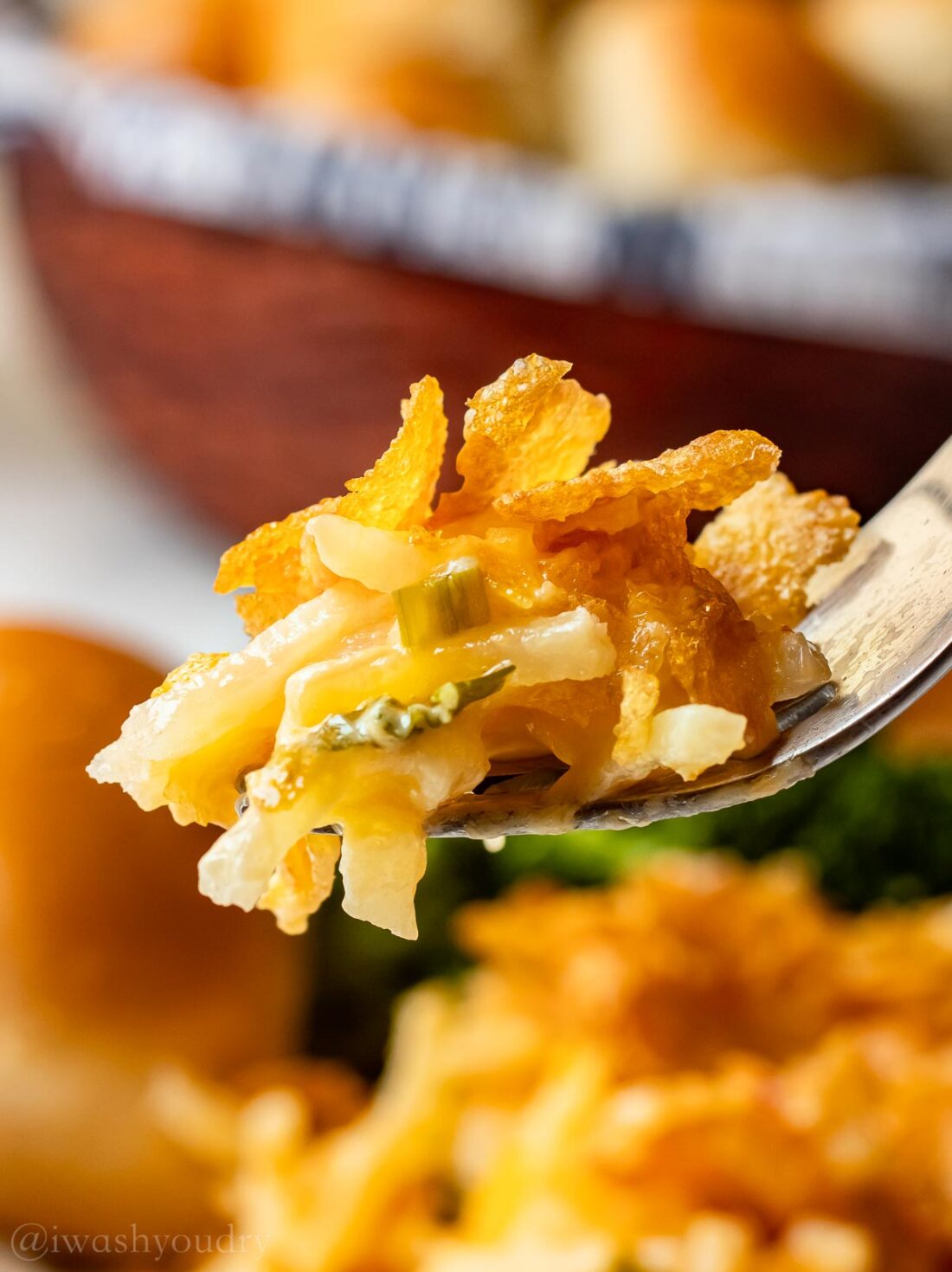 forkful of casserole potatoes and green onions.