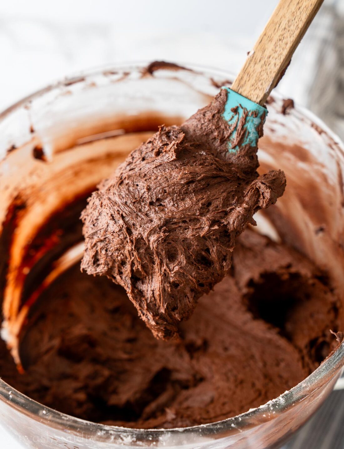 spatula with chocolate frosting on it.