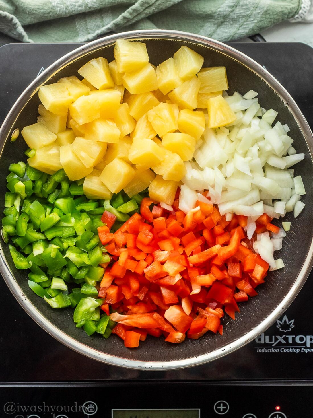 fresh veggies and pineapples in skillet.