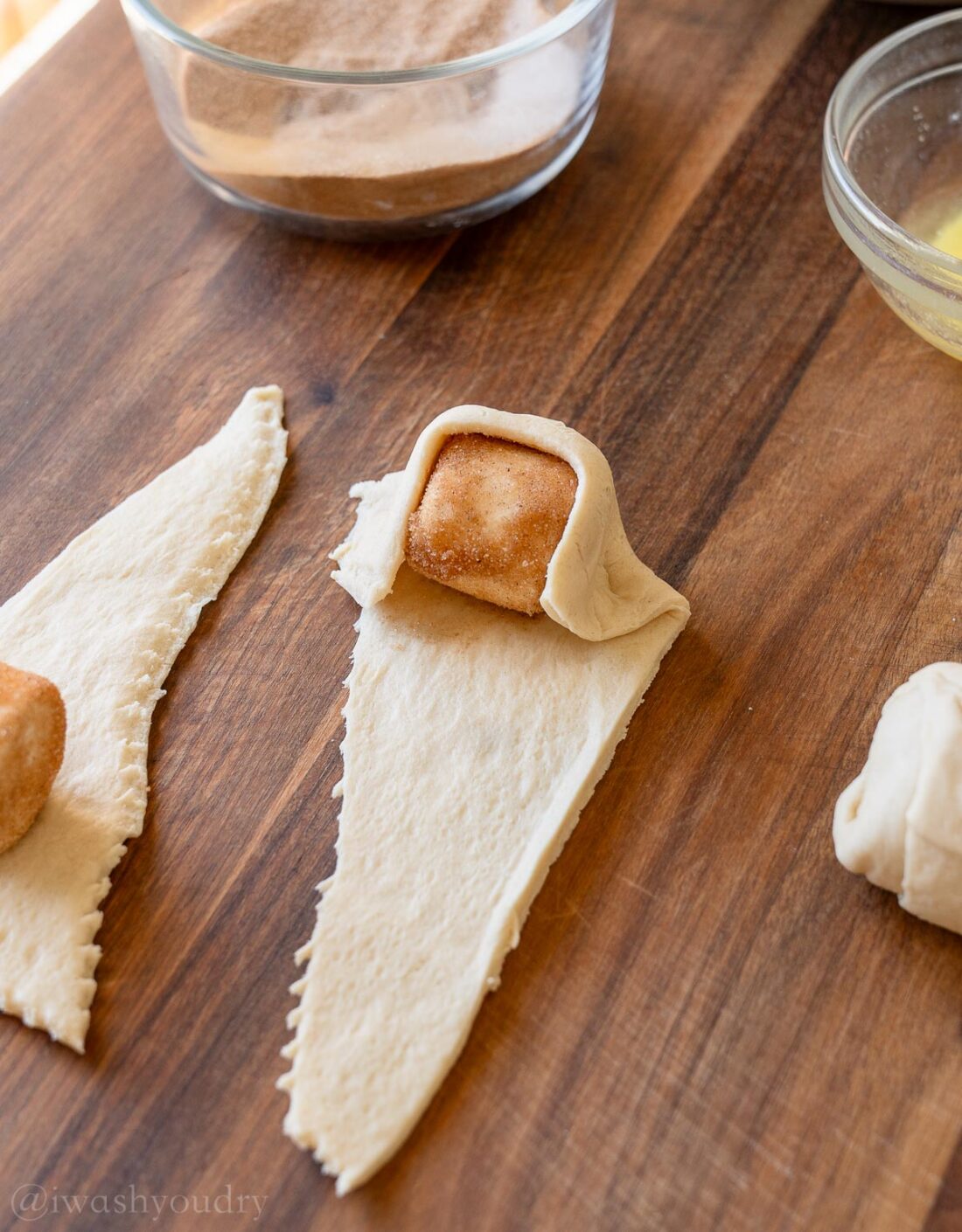 rolling coated marshmallow in crescent dough.