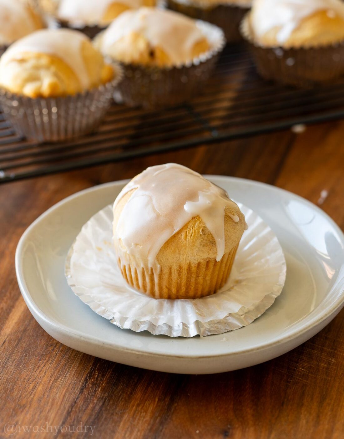 baked Resurrection Rolls on white plate with muffin wrapper around it.