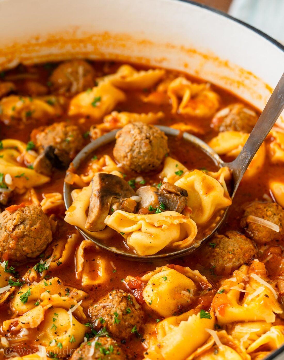 Ladleful of italian meatball soup. 