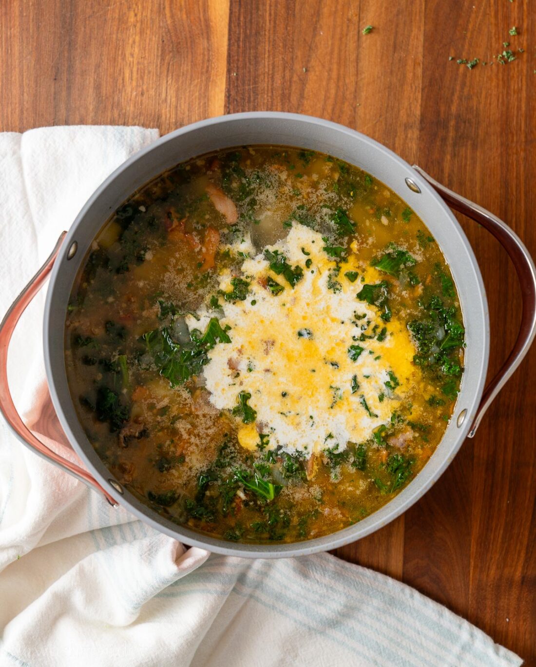 Cream poured into zuppa toscana. 