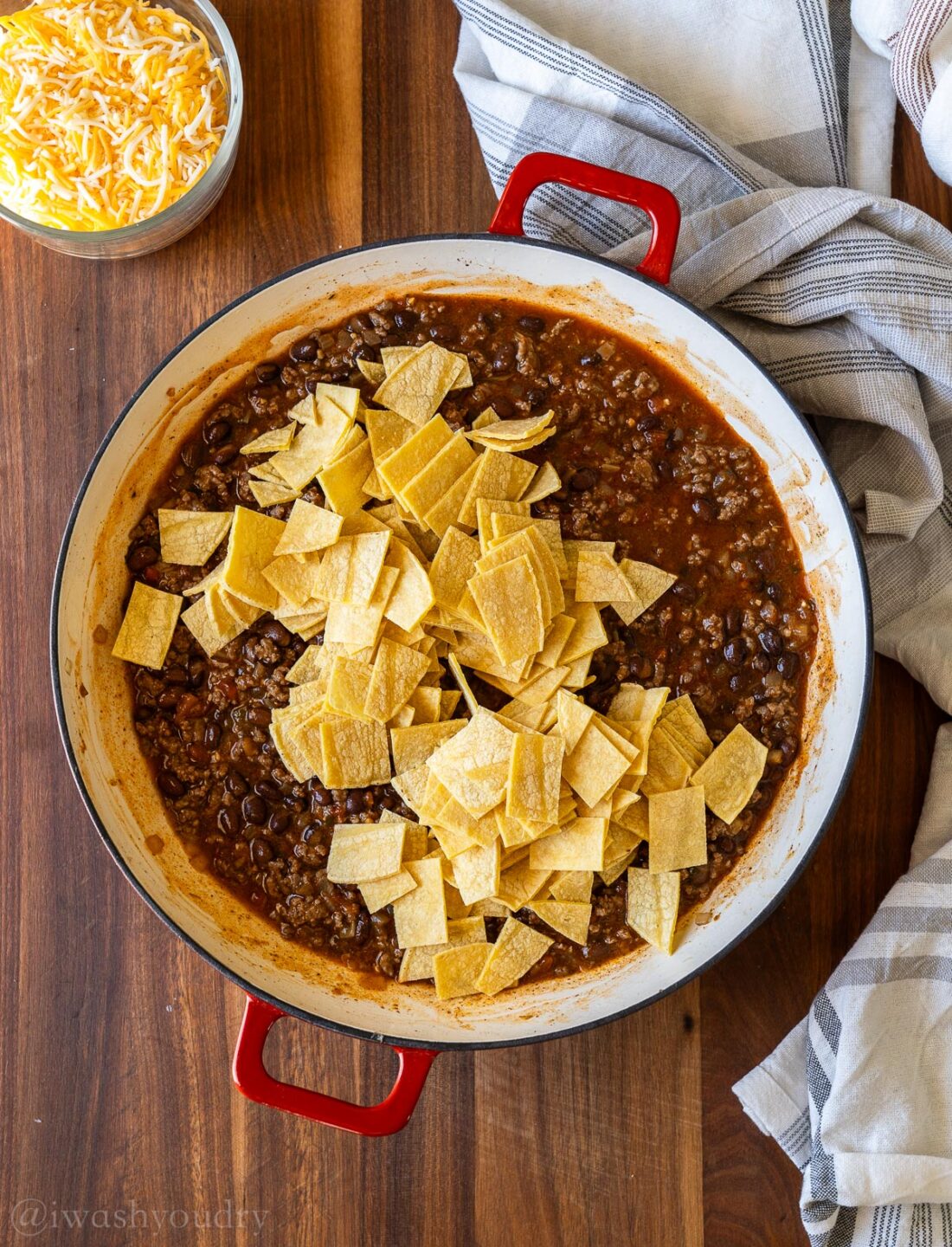 saucy beef enchilada mixture topped with cut yellow corn tortillas.