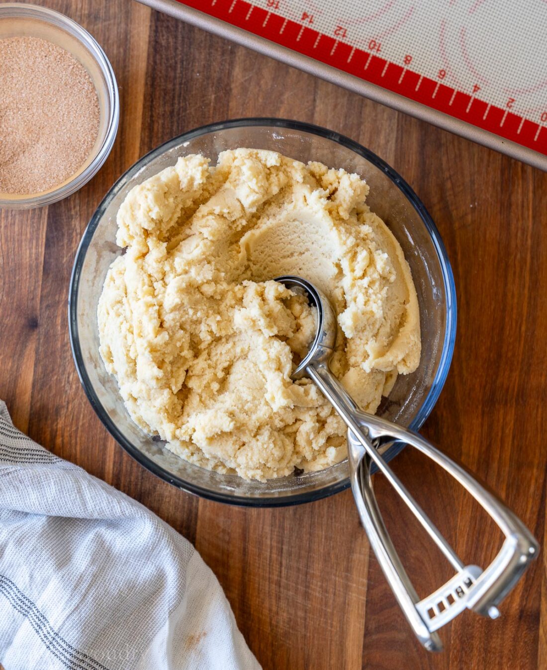 cookie dough in mixing bowl with cookie scoop.