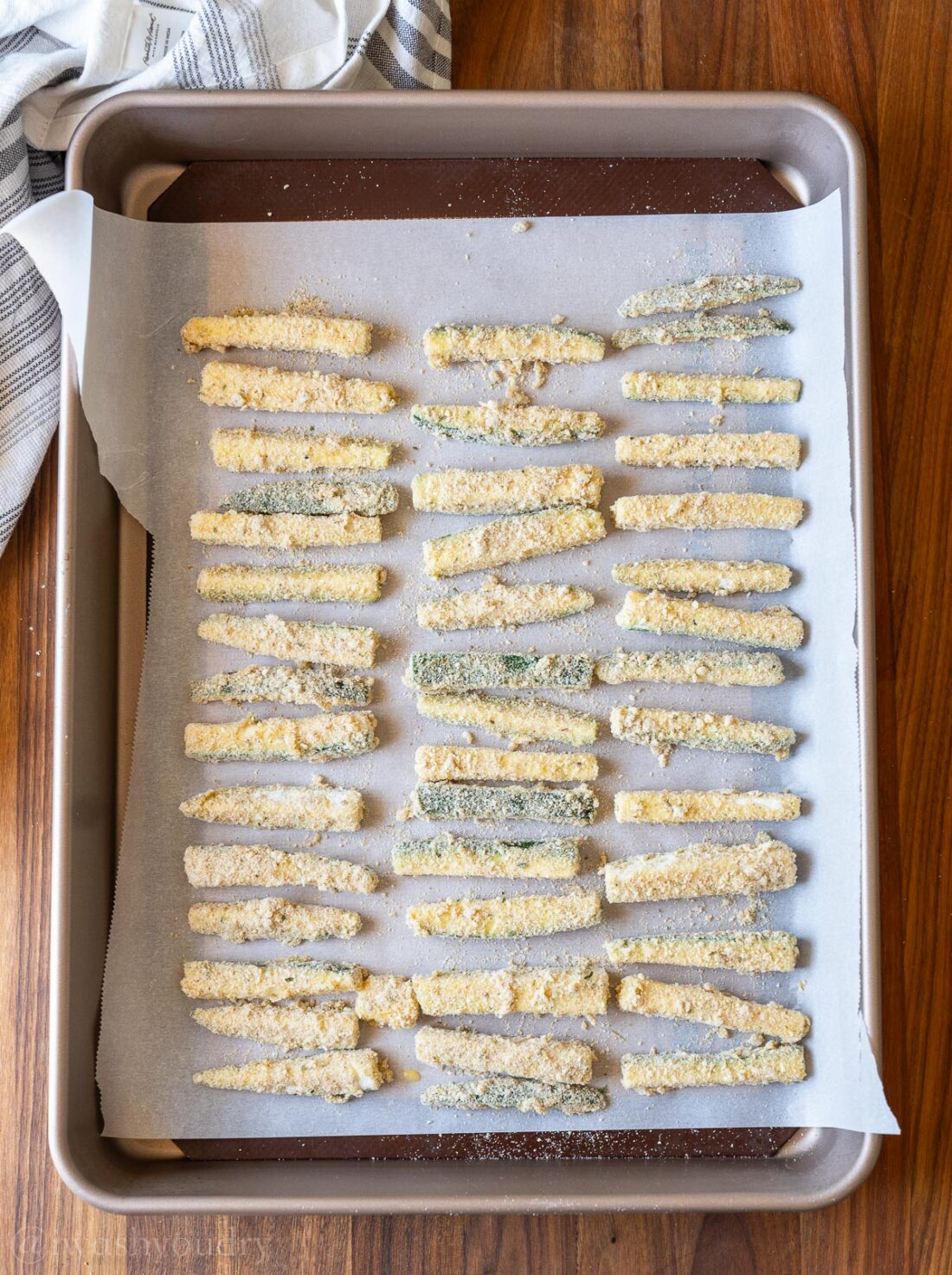 baking sheet lined with zucchini fries.